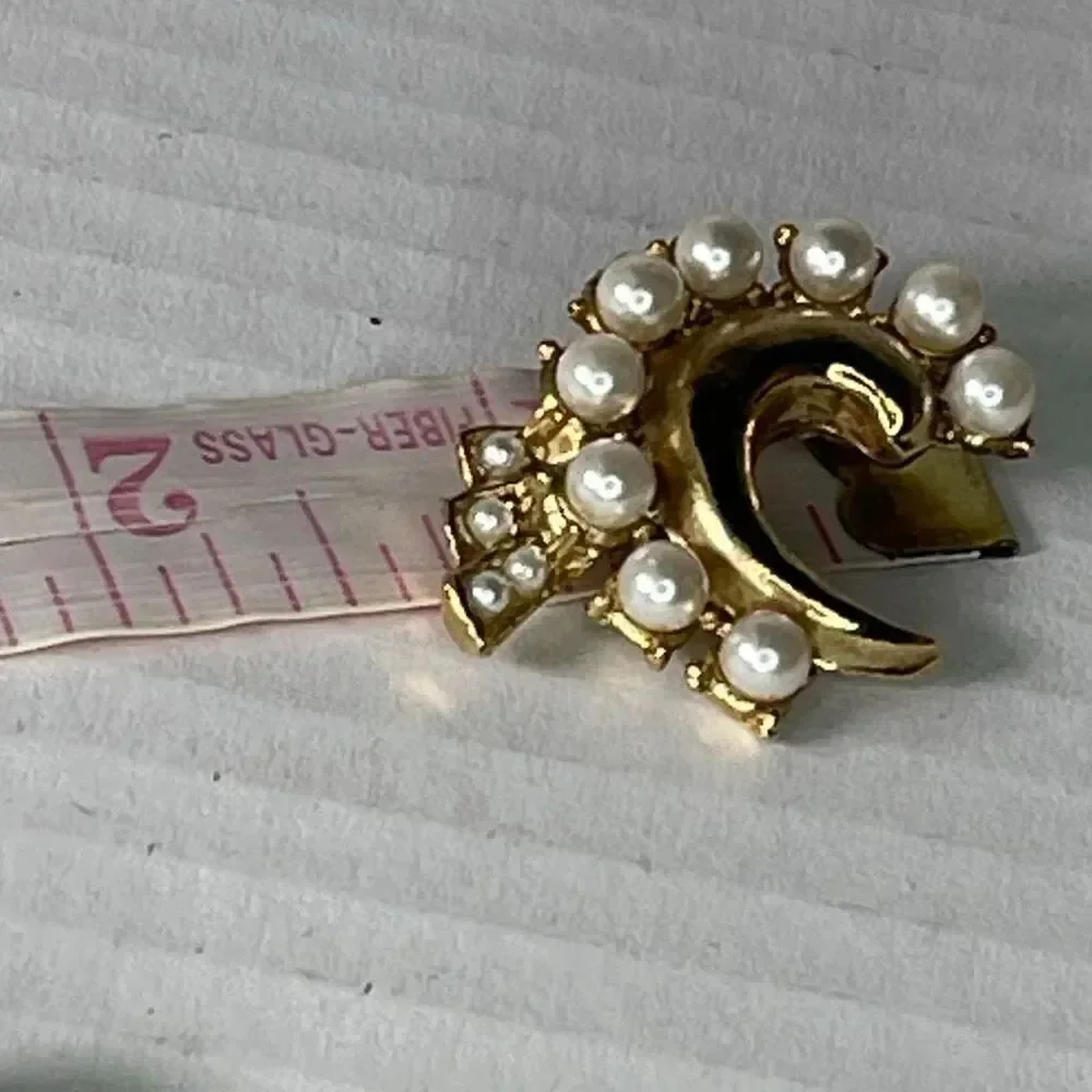 Vintage faux pearl crescent brooch with a small cluster tail accent.